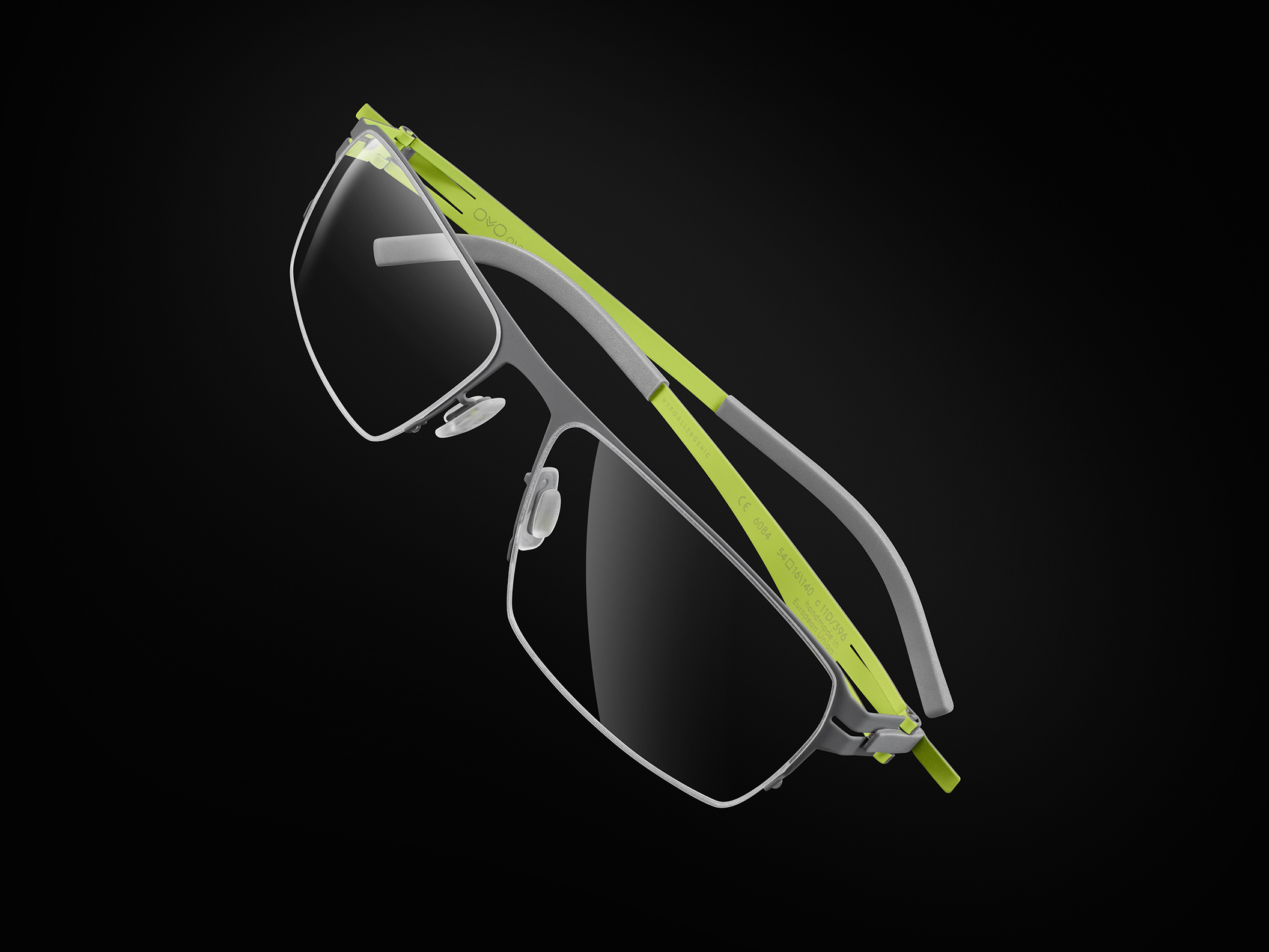 OVVO Optics silver optical frame with neon yellow temples in an angled product shot on black background