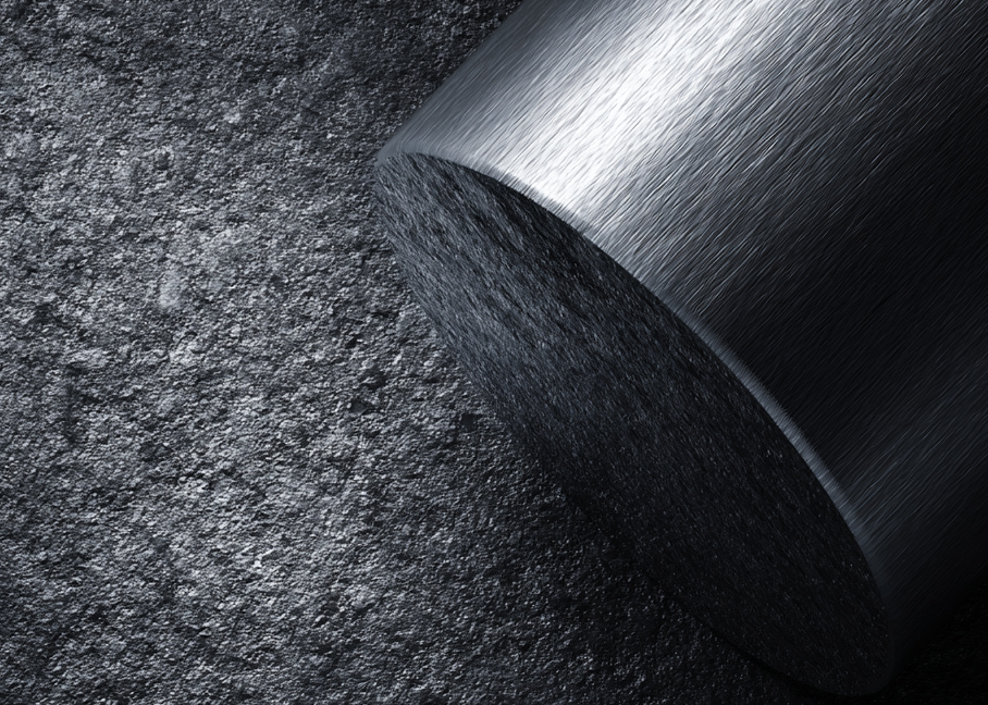 OVVO Optics Ti2 close-up of a brushed titanium cylinder on a dark textured surface