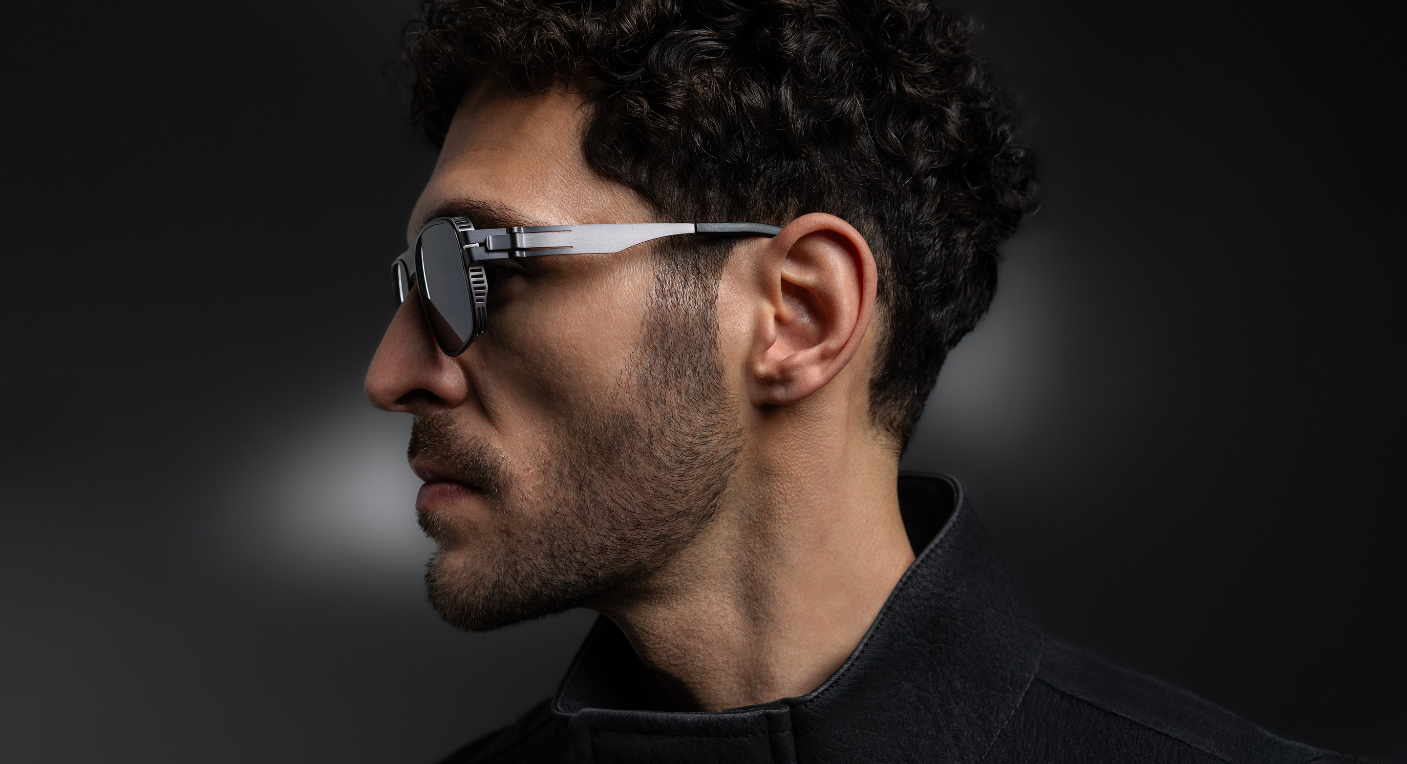 OVVO Optics Ti2 Collection side-profile portrait of a man wearing titanium sunglasses
