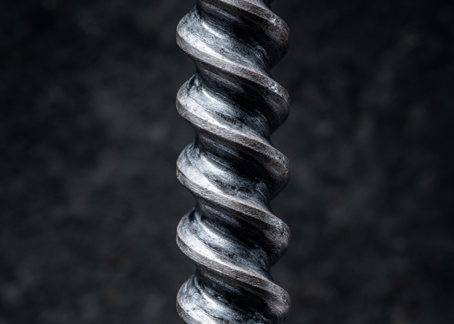 OVVO Optics Ti2 close-up of a twisted titanium rod against a dark background