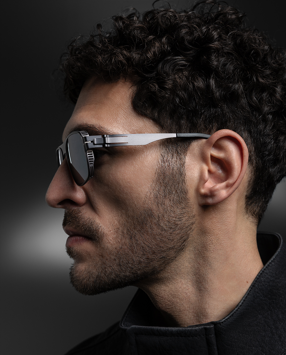 OVVO Optics Ti2 Helios sunglasses side-profile portrait of a man in a dark turtleneck