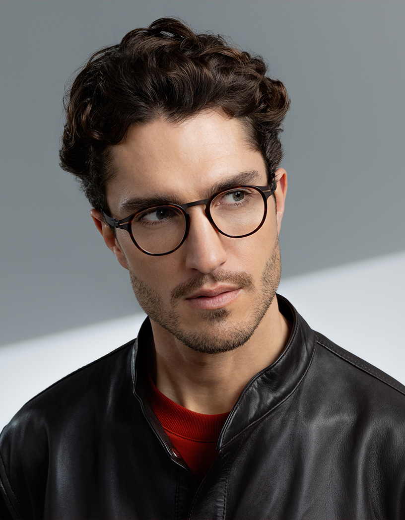 Man wearing OVVO Optics DUO Calvin round tortoiseshell eyeglasses and a black leather jacket