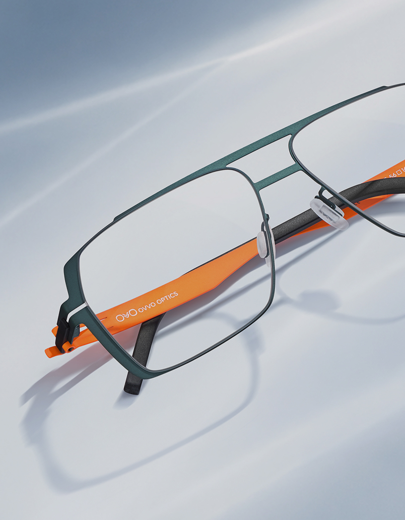 OVVO Optics green geometric optical frame with orange temples in a studio product shot for the summer collection